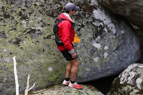 Una persona junto a un gran bloque rocoso en Oímbra. La figura permite apreciar la escala de los bloques que aparecen en este paisaje.
