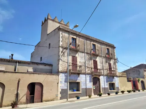 Can Gustà, en el carrer Girona: una fachada del tejido urbano de Bàscara, donde las casas tradicionales de piedra acompañan el núcleo histórico.